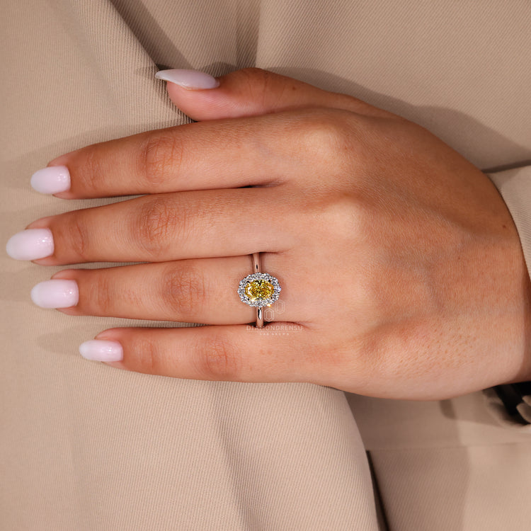 Handmade oval diamond engagement ring with round cut side diamonds.