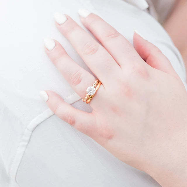 A woman’s hand showing a minimalist gold wedding band ring A woman’s hand showing a minimalist gold wedding band ring