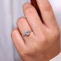 Lab grown oval ring with cluster of round side stones.