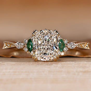 Art Deco cushion diamond ring with round and marquise side stones.