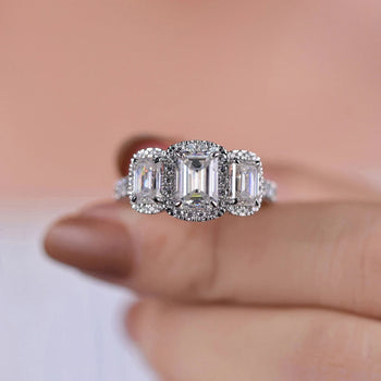 3 stone emerald cut ring with unique design.