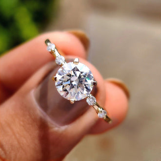 Round cut distance pave engagement ring offers classic charm.