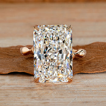 Radiant cut diamond ring with round diamond distance pave band.