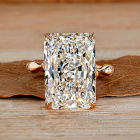 Radiant cut diamond ring with round diamond distance pave band.