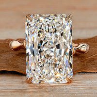 Radiant cut diamond ring with round diamond distance pave band.