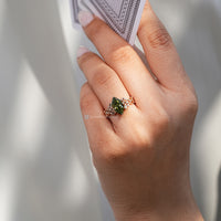 Green Dutch marquise diamond ring with round side stones.