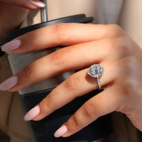 Round cut halo design with cushion old mine diamond and pave accents.