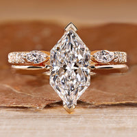 Dutch marquise wedding ring with hidden halo and round accents.
