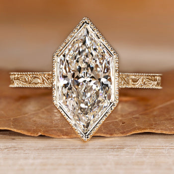 Art Deco engagement ring with Dutch marquise center stone and milgrain details.