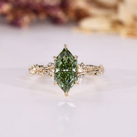Dutch marquise ring with nature inspired design and round side stones.