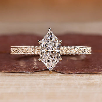 Dutch marquise ring in solitaire style with ocean waves design band.