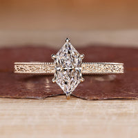Dutch marquise ring in solitaire style with ocean waves design band.