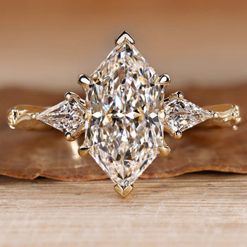 Trilogy diamond ring with a Dutch marquise center stone.