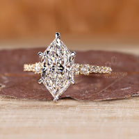 Two tone metal Dutch marquise ring with hidden halo and pave accents.