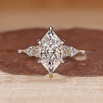Dutch Marquise Engagement Ring with round and kite side stones in muse setting.