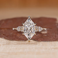 Dutch Marquise Engagement Ring with round and kite side stones in muse setting.