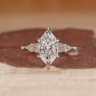 Dutch Marquise Engagement Ring with round and kite side stones in muse setting.