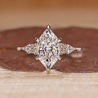 Dutch Marquise Engagement Ring with round and kite side stones in muse setting.
