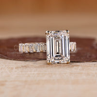 Handmade emerald cut diamond ring with pave band design.