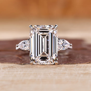 Emerald cut lab grown diamond ring with pear side stones.