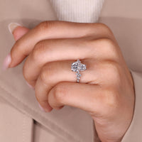 Coffin center stone ring with round side stone details.