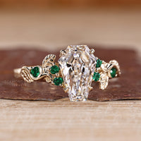 IGI certified coffin cut diamond ring with emerald accents.