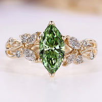 Green marquise diamond ring with round and marquise side stones.