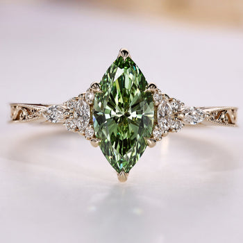 Art Deco diamond ring with a green marquise center stone.