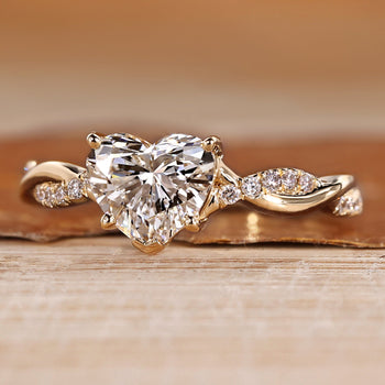 Heart cut engagement ring with twisted shank with round accents.