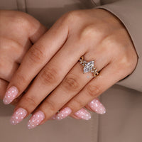 Marquise center stone ring with nature inspired design.