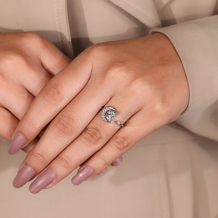White gold engagement ring with a moon fidget ring twist.