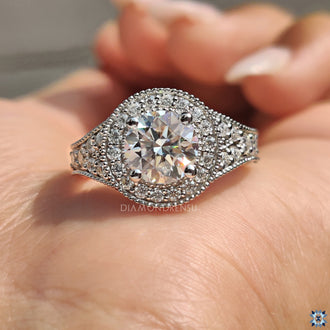 Stunning white gold engagement ring featuring a vintage moissanite center stone.