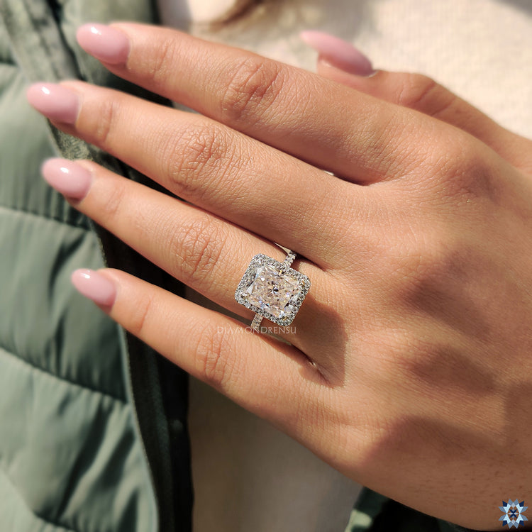 Halo engagement ring featuring a radiant cut moissanite for extra shine.