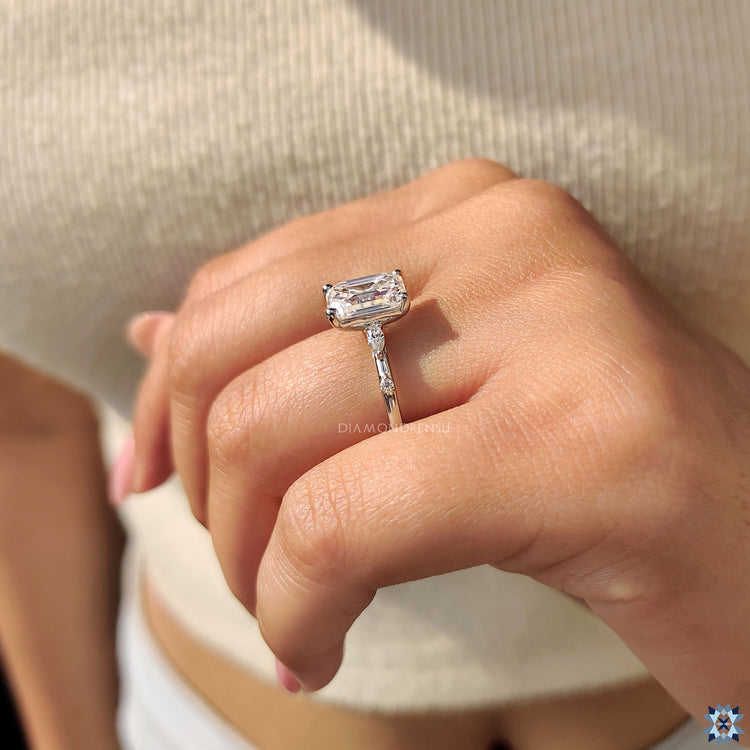 Muse ring featuring an emerald cut moissanite stone in a modern design.