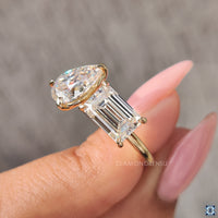 Handcrafted handmade ring with a brilliant pear cut moissanite and emerald cut moissanite.