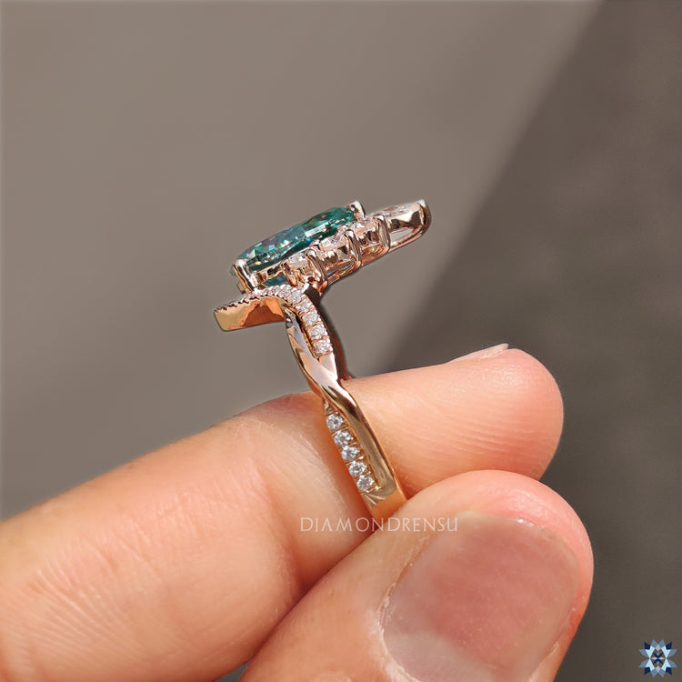 Twisted pave engagement ring with pear cut cyan blue moissanite