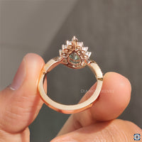 Rose gold engagement ring with pear cut cyan blue moissanite