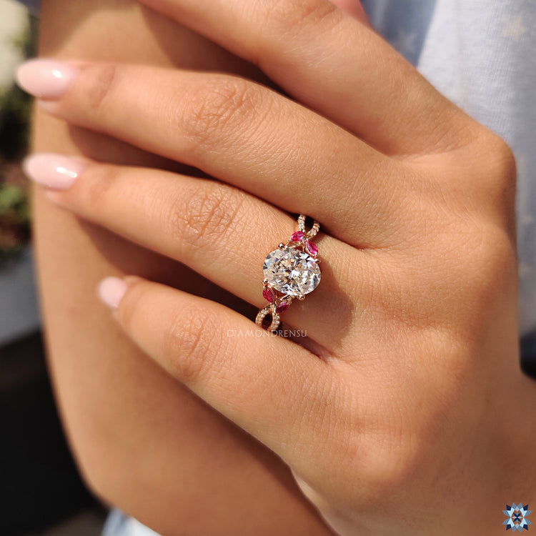 Red marquise side stones on a rose gold ring.