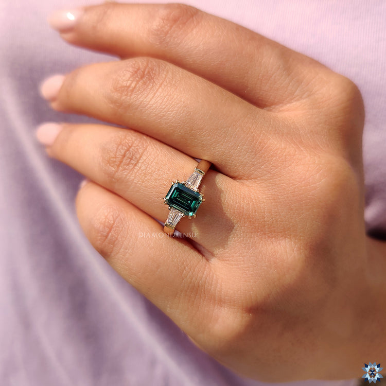 Stunning Yellow Gold Engagement Ring with an Emerald Cut Moissanite, perfect for a luxurious proposal.