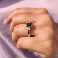 Three Stone Emerald Ring crafted with 2 Tapered Baguette Side Stone for added sparkle.