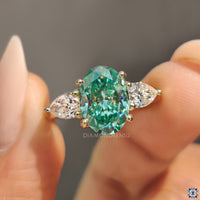 Handmade jewelry pear side stones moissanite yellow gold ring.