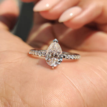 Pear Shaped Moissanite Ring with elegant pave setting.