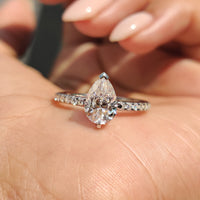 Pear Shaped Moissanite Ring with elegant pave setting.