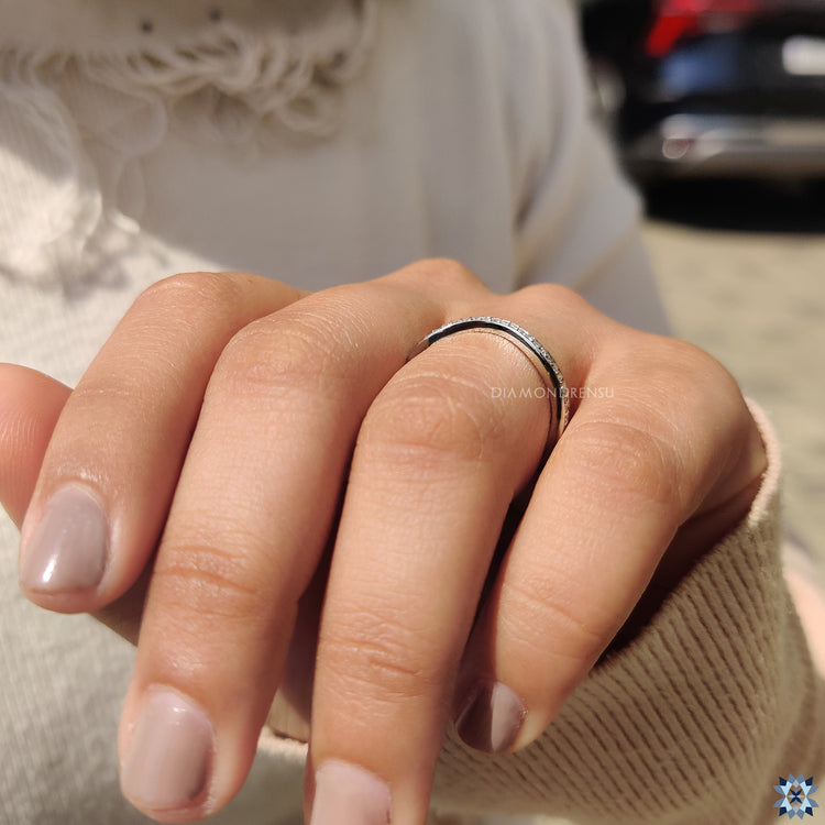 Round cut moissanite wedding band in gold.