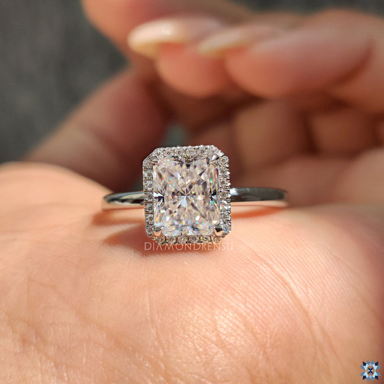 Round cut moissanite set in a delicate engagement ring.