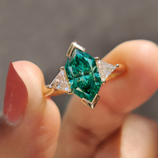 Green moissanite engagement ring with a stunning three-stone design.