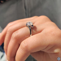 Purple moissanite center stone with vibrant hue.