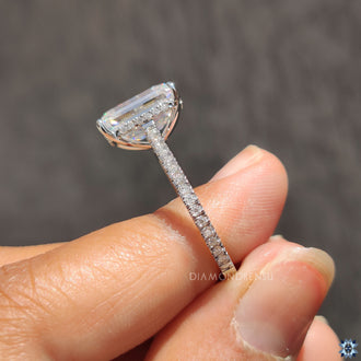Polished white gold ring resting on a marble surface.