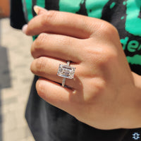 Round cut moissanite shining brightly in a solitaire design.