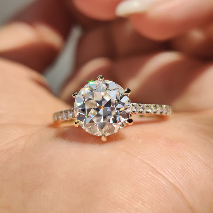 Hidden halo round engagement ring with detailed craftsmanship.